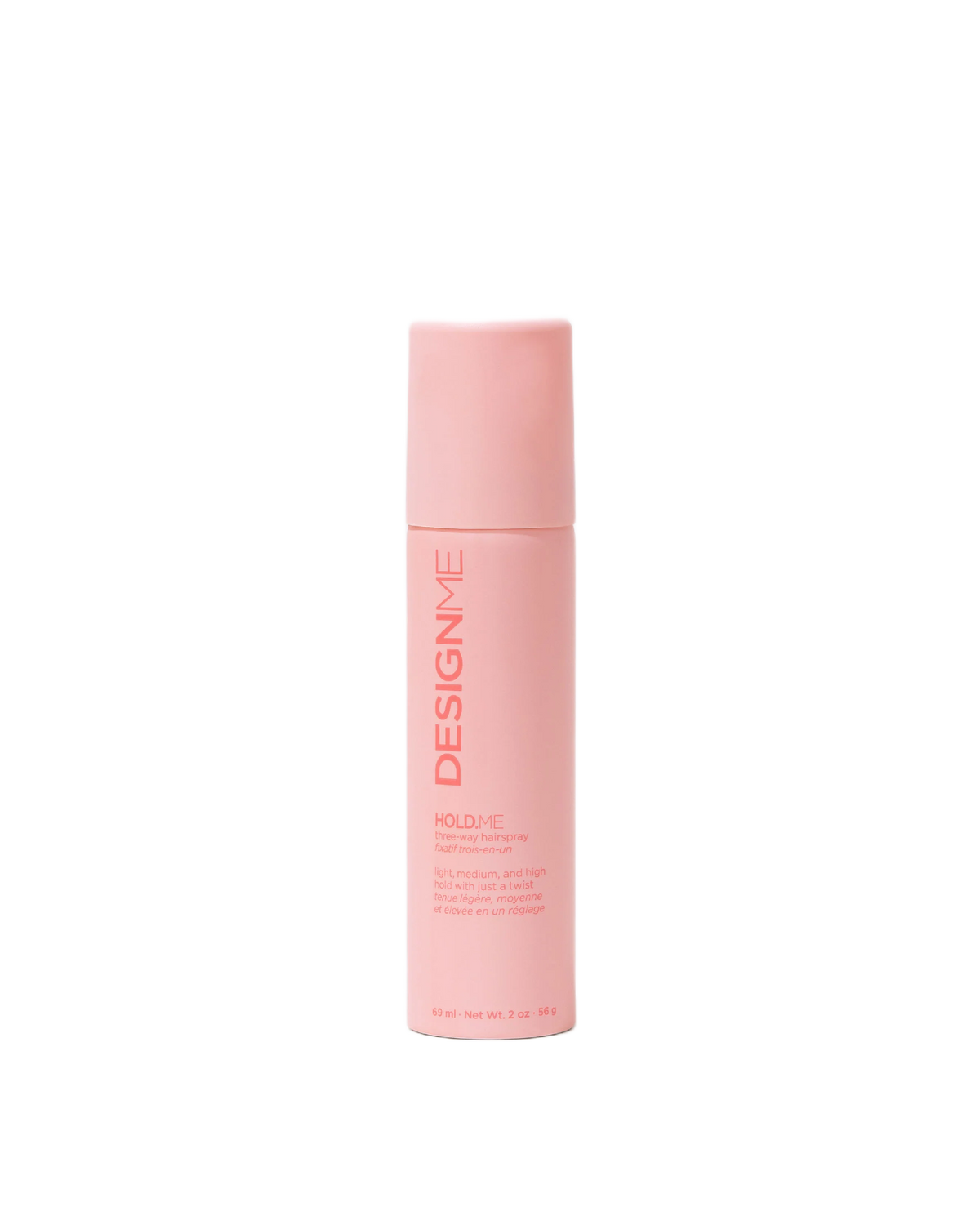 A tall, cylindrical pink bottle of Design Me Hold+ve hair hold spray, shown against a solid white background.