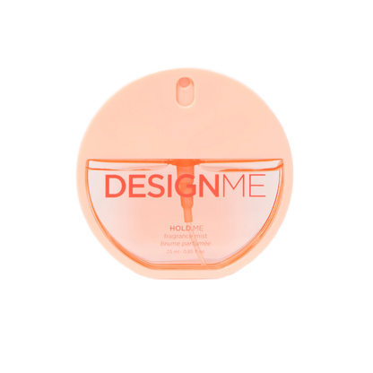 A round, translucent peach-colored perfume bottle labeled 'DESIGNME HOLD ME' on a solid white background.