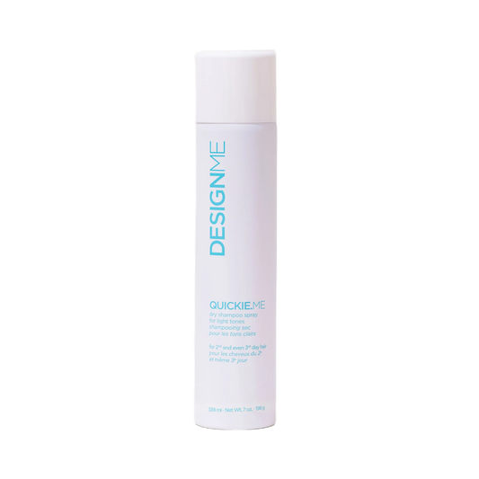 A white cylindrical bottle of DesignMe Quickie-Me hair product, featuring light blue text, centered on a plain white background.