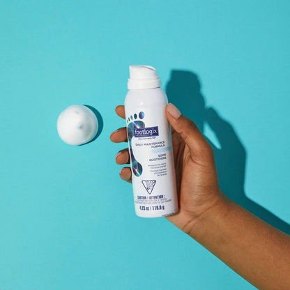 Hand holding a can of footlogix daily maintenance formula
