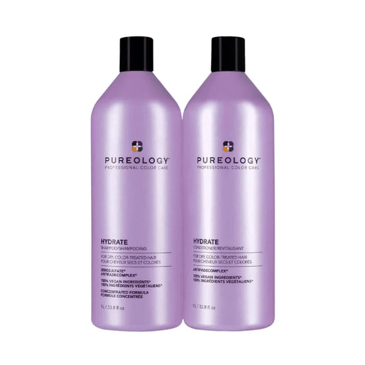 Two bottles of Pureology Hydrate shampoo and conditioner on a white background