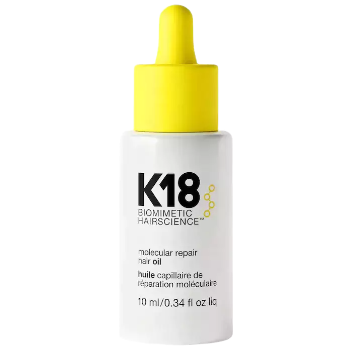 K18 hair oil bottle with yellow dropper on a white background
