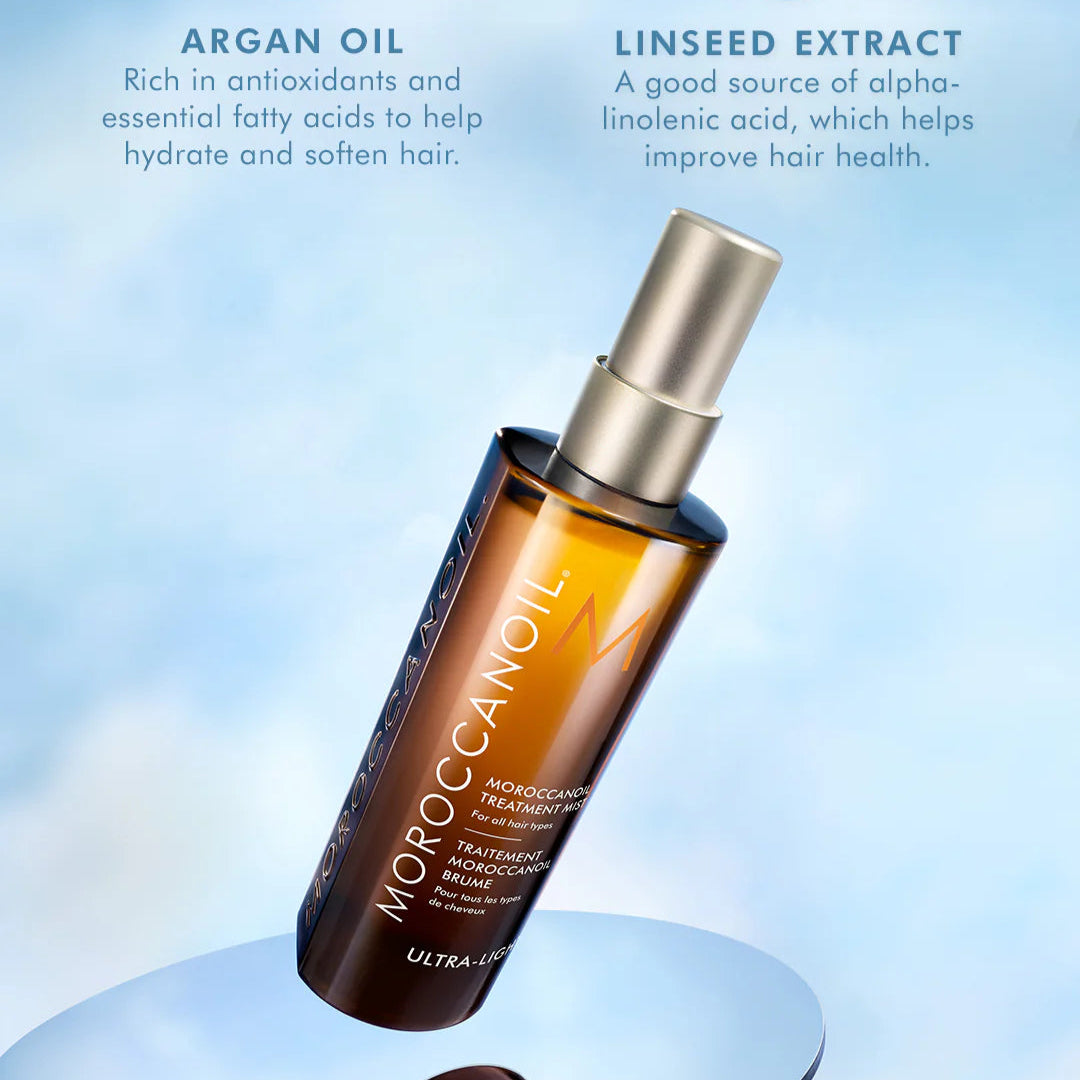 Moroccanoil hair treatment bottle with argan oil and linseed extract text on a light blue background
