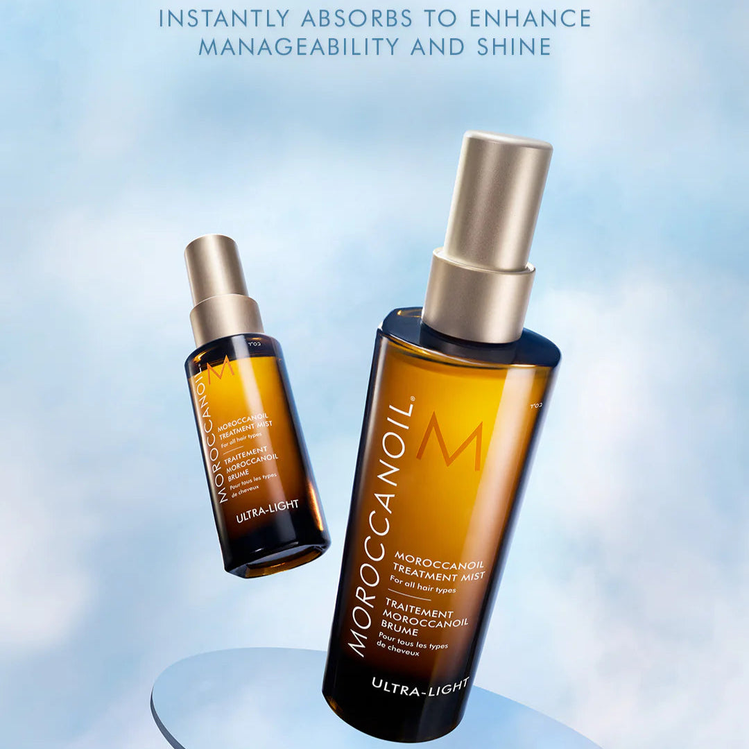 Moroccanoil Ultra-Light dry oil spray bottles on a light blue background