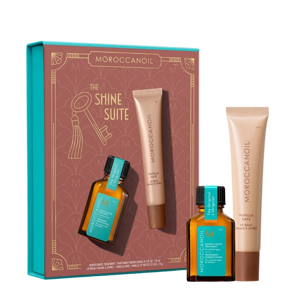 Moroccanoil The Shine Suite gift set featuring a brown and turquoise box with two small amber bottles and two beige tubes, including Vanilla Date body wash and body butter, on a white background.