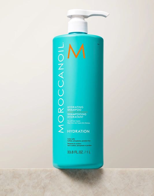 Moroccanoil shampoo bottle on a tiled wall