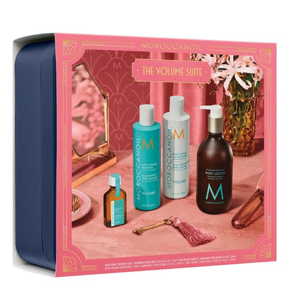 Moroccanoil The Volume Suite gift set in a navy blue tin with a pink illustrated front panel showing severalMoroccanoil haircare bottles and containers.
