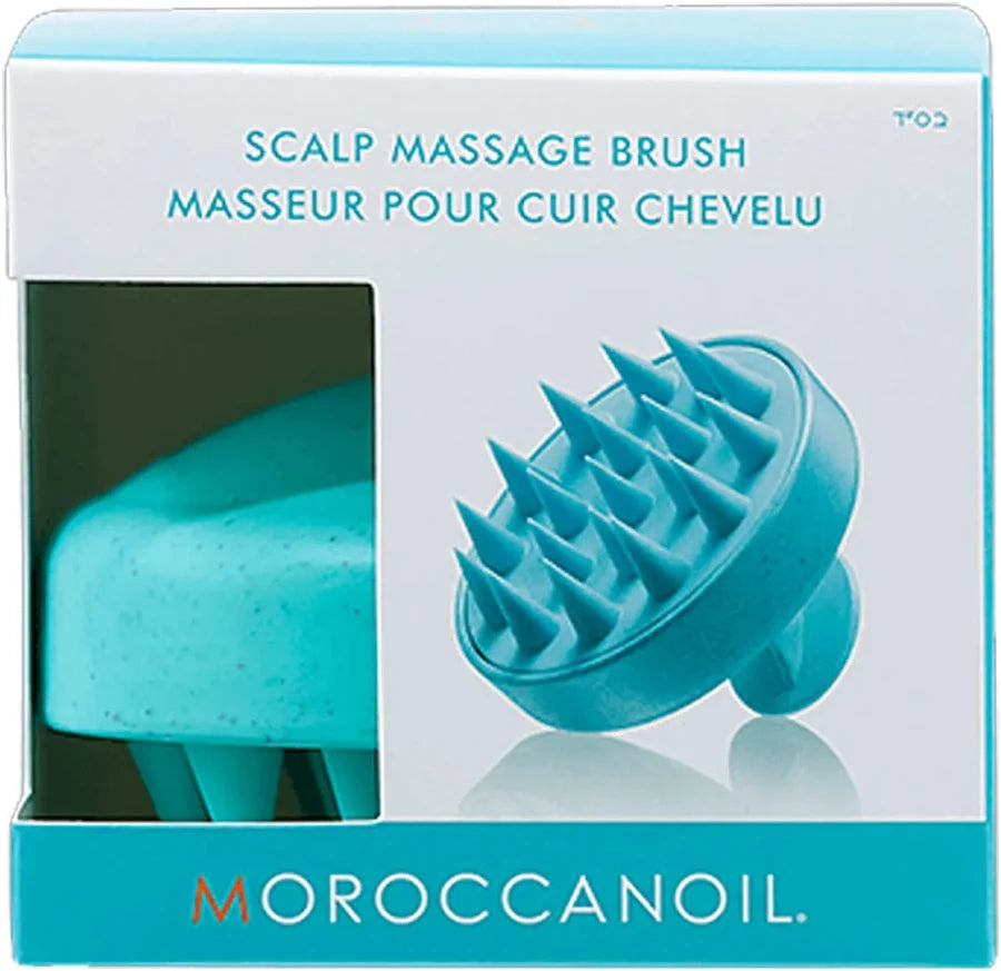 Turquoise scalp massage brush in packaging with Moroccanoil branding.
