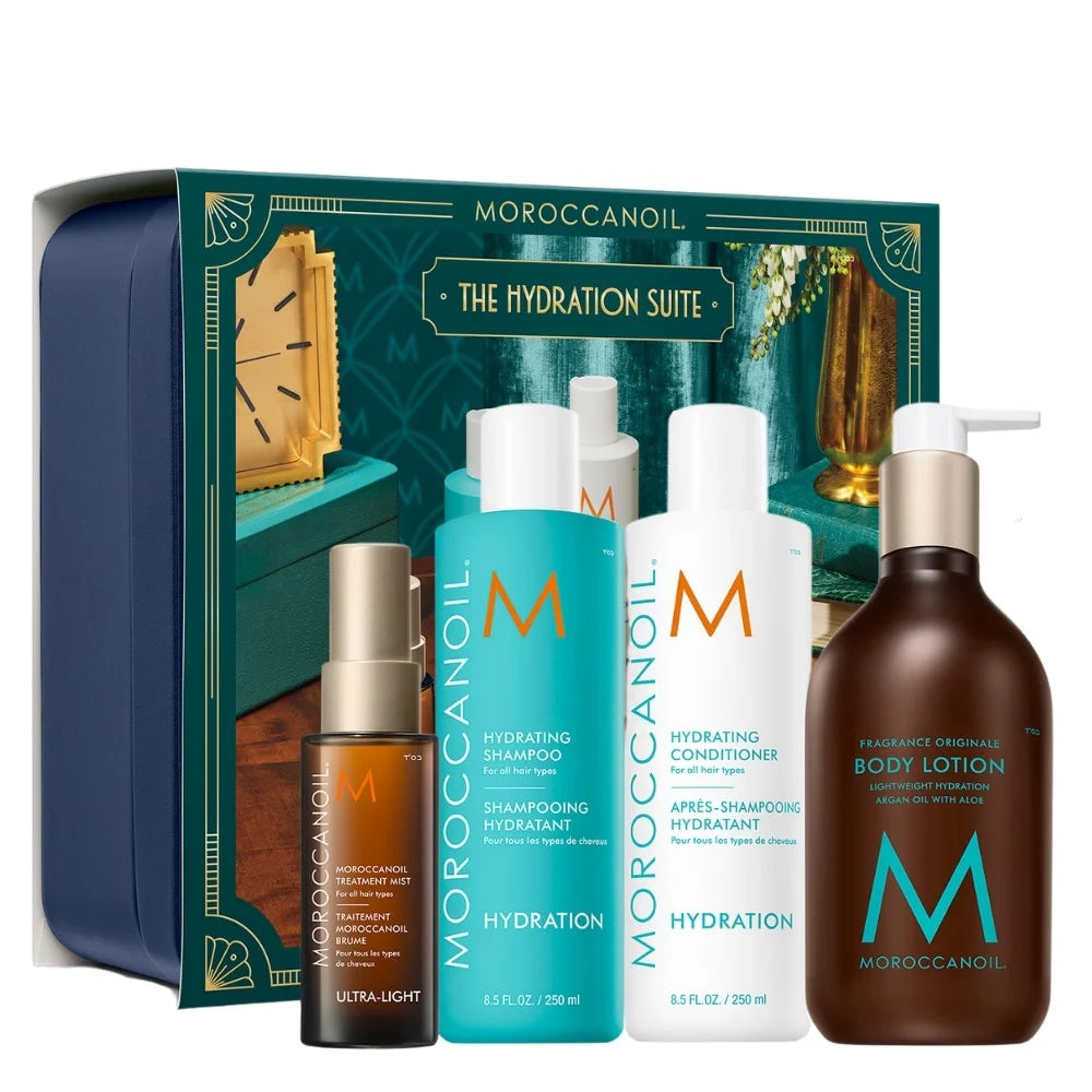 Moroccanoil The Hydration Suite gift set featuring a teal and navy blue box, five bottles (shampoo, conditioner, hydrating mist, body lotion, and oil), and a small amber bottle, arranged on a clean white background.