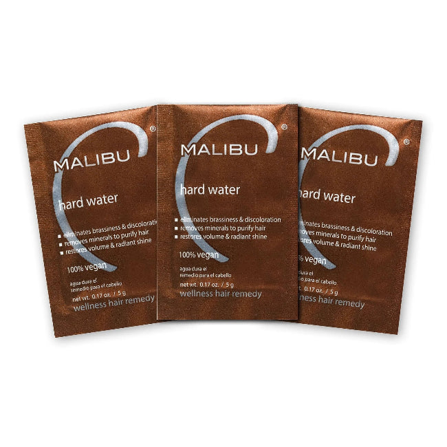 Three Malibu hard water wellness hair remedy packets on a white background