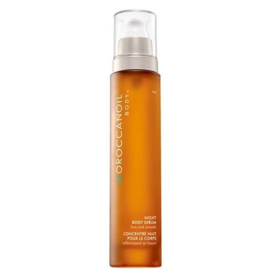 Moroccanoil Body+ Night Body Serum in an amber orange bottle with a clear cap and white pump, shown on a plain white background.