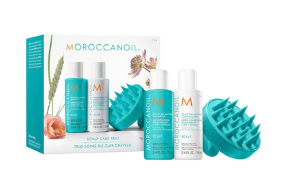 Moroccanoil scalp care products including bottles and a box on a white background
