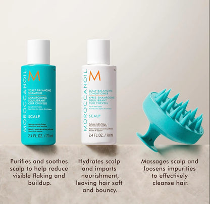 Moroccanoil shampoo and conditioner bottles with a scalp massager on a beige background