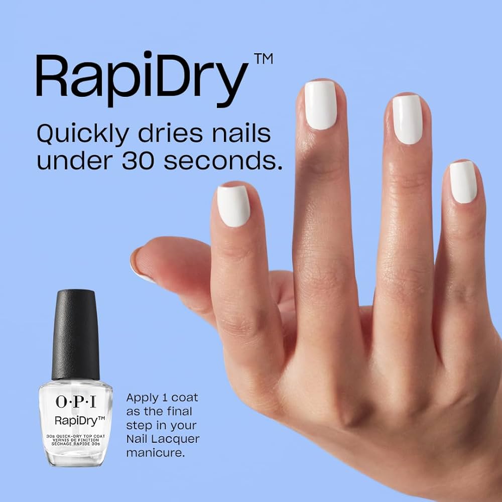 Hand with white nail polish and OPI RapiDry nail polish bottle on a blue background