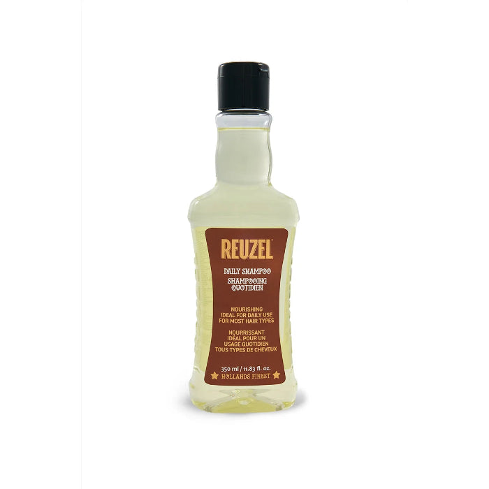 A 320 ml bottle of Reuzel Daily Shampoo Quotidien, featuring a clear plastic bottle filled with pale yellow liquid, a black cap, and a brown label with gold lettering.