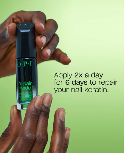 OPI nail repair product held by a hand with a green background
