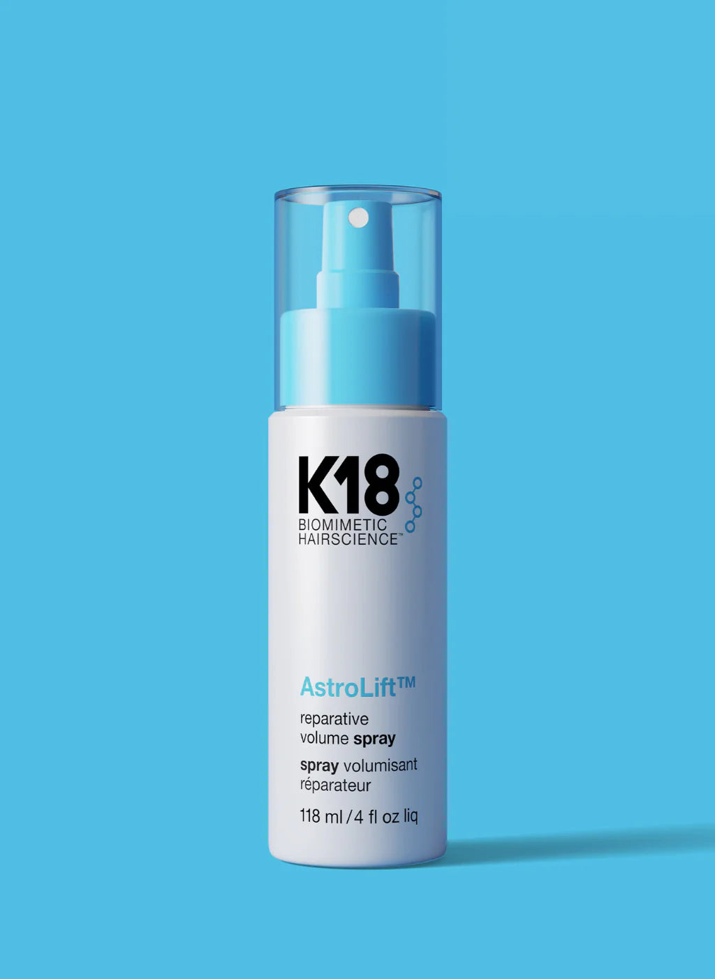 K18 Astrolift hair spray bottle on a blue background