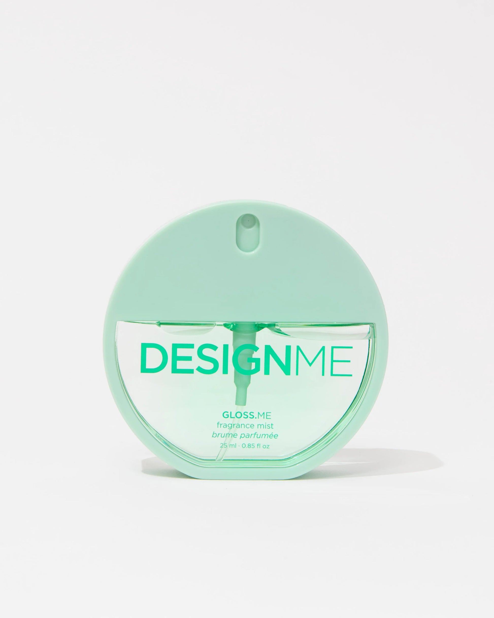 A mint green round bottle of DESIGN ME Gloss Me fragrance mist on a clean white background.