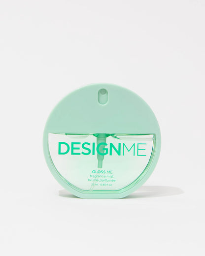 A mint green round bottle of DESIGN ME Gloss Me fragrance mist on a clean white background.