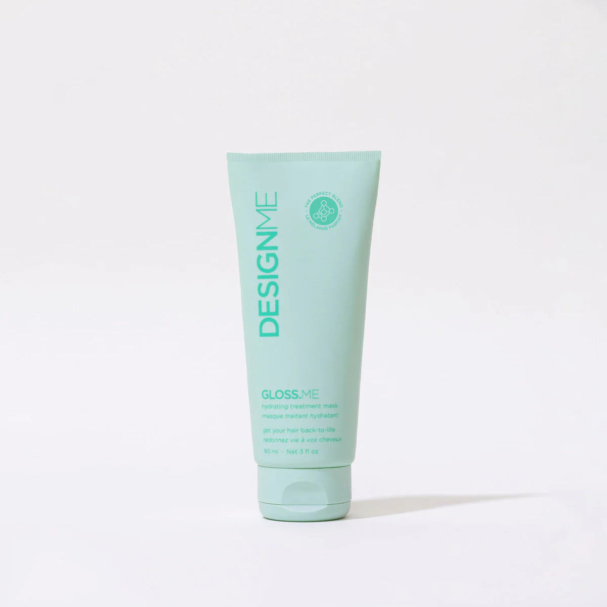 Mint green tube of DESIGNME hair product on a white background