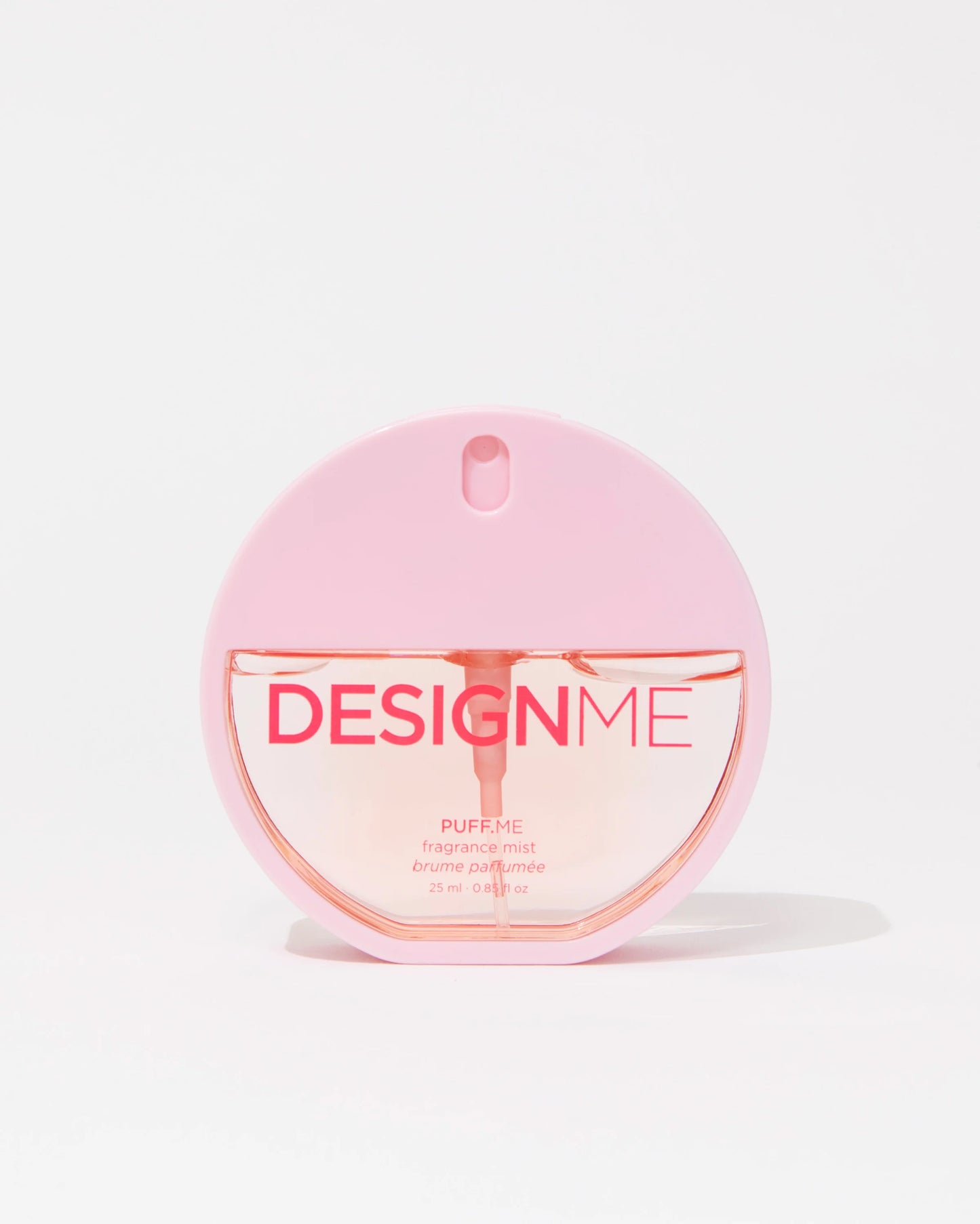 A pink circular perfume bottle labeled 'DESIGNME PUFF.ME' with a matching pink cap, centered on a clean white background.