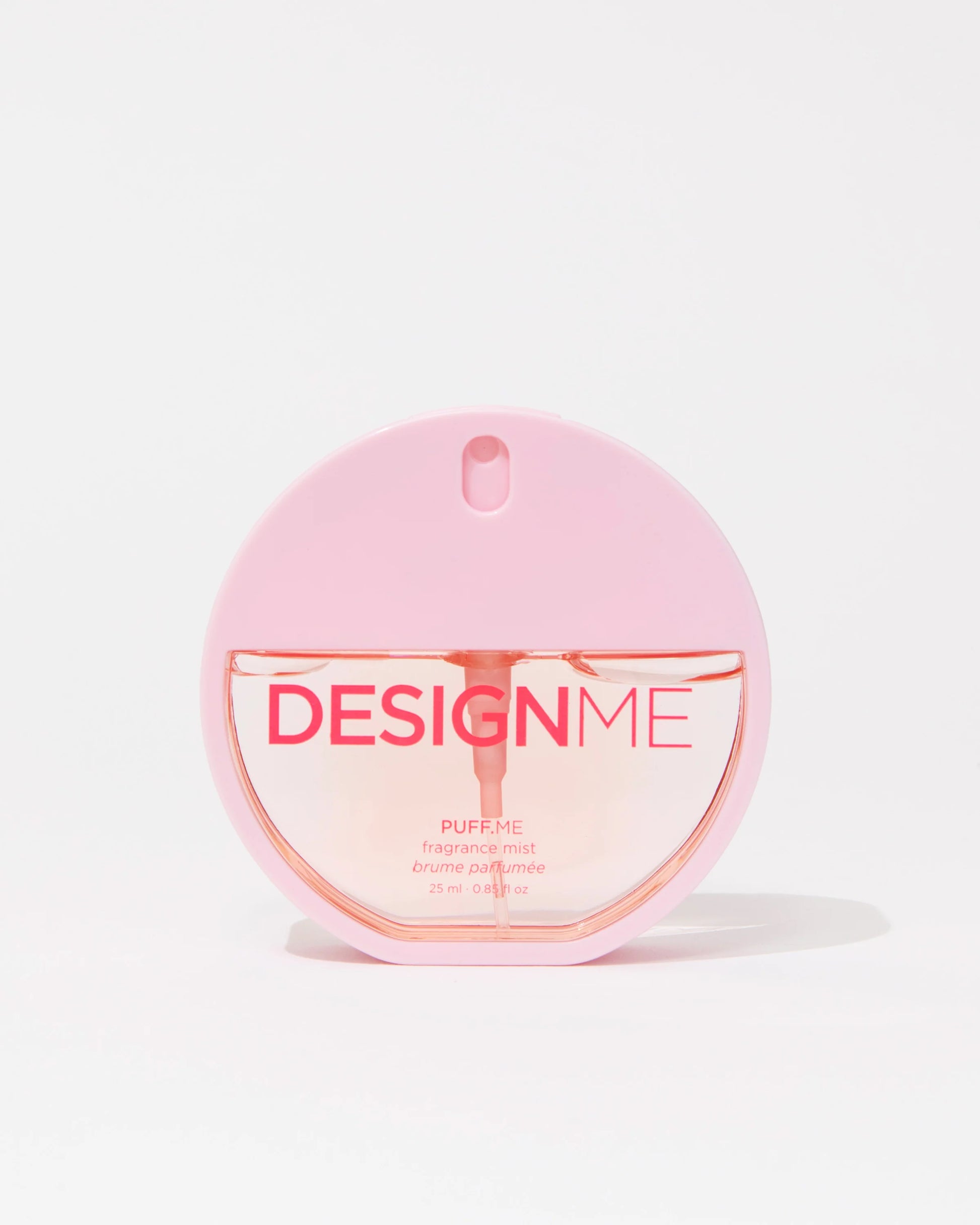 A pink circular perfume bottle labeled 'DESIGNME PUFF.ME' with a matching pink cap, centered on a clean white background.