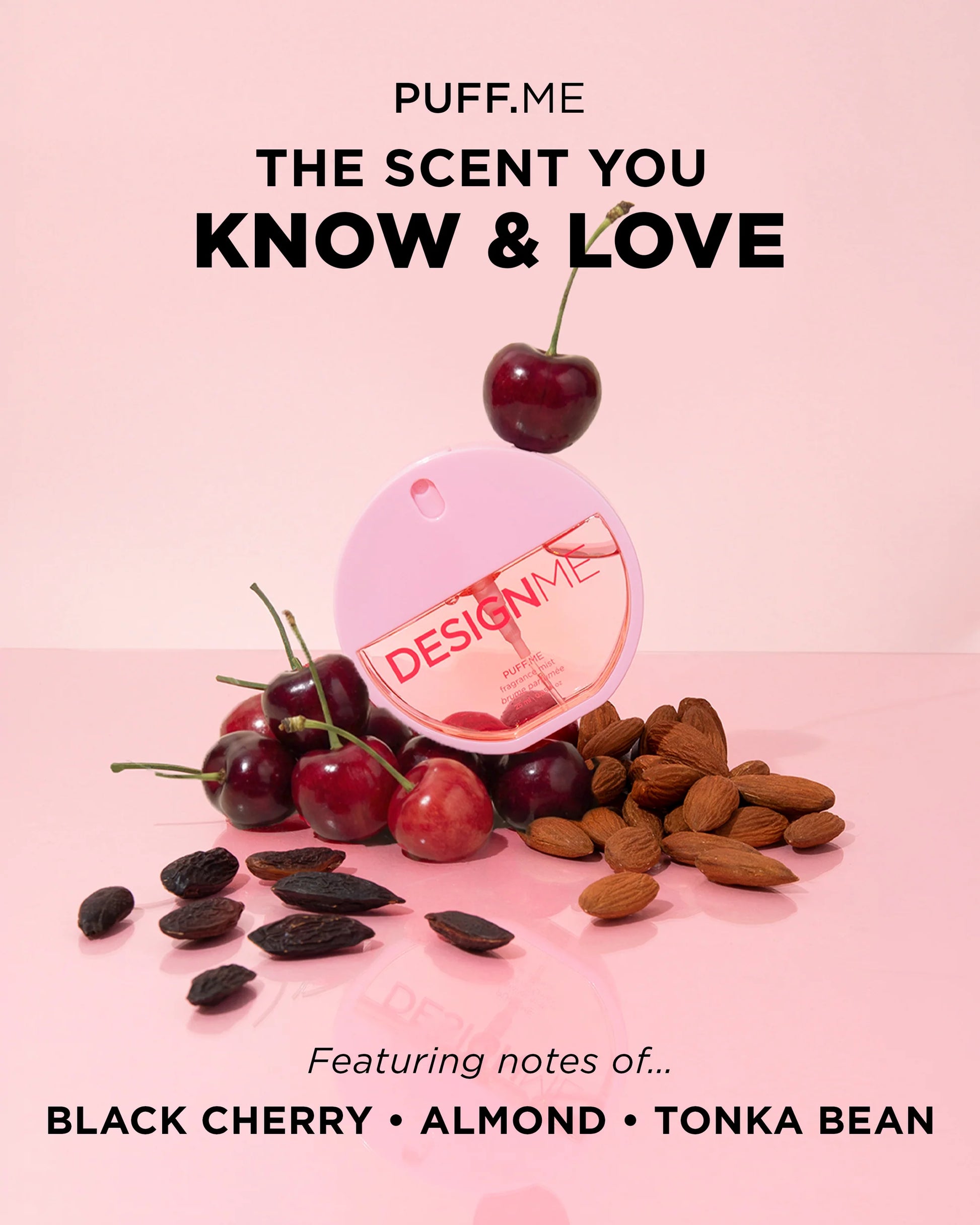 A pink perfume bottle labeled 'DESIGNME' with cherries and almonds arranged around it on a pink background, alongside promotional text reading 'PUFF,ME THE SCENT YOU KNOW & LOVE' and 'Featuring notes of.