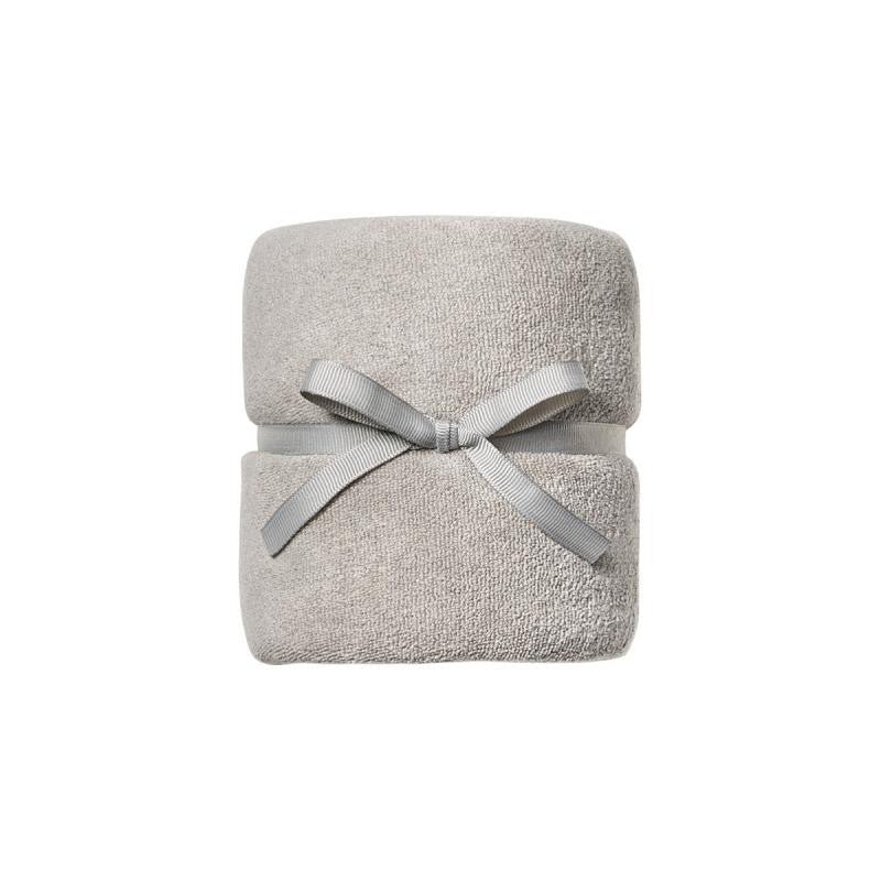 A folded light gray terry cloth towel wrapped with a matching gray ribbon bow, centered on a plain white background.