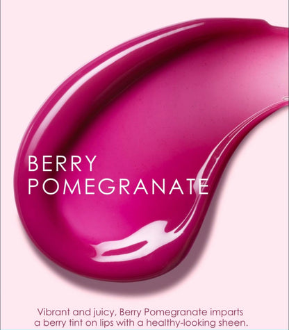 Close-up of berry pomegranate lip color with a swatch on a pink background