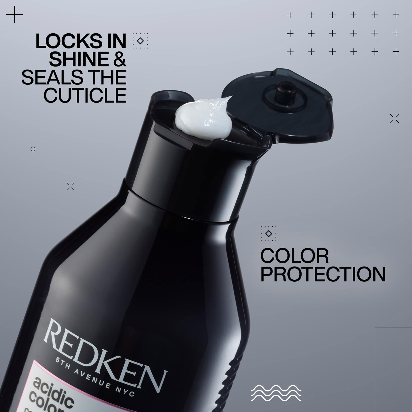 Redken hair product bottle with text on a gray background