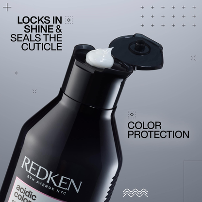 Redken hair product bottle with text on a gray background