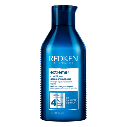 Blue bottle of Redken extreme conditioner on a white background