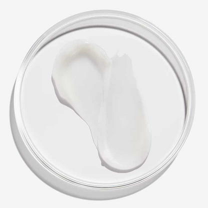 Jar of white cream with a visible scoop on a white background