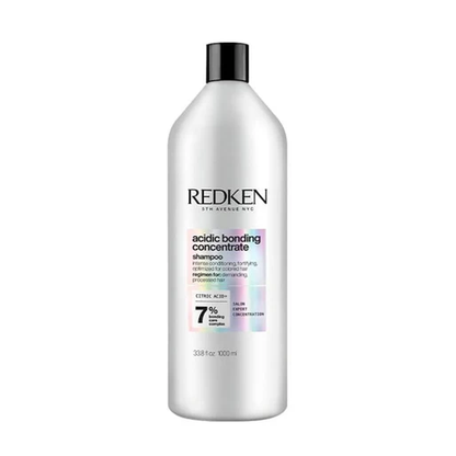 Redken bottle of acidic bonding concentrate shampoo on a white background