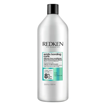 Redken bottle of acidic bonding curls conditioner on a white background