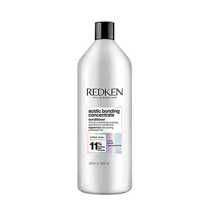 Redken bottle of acidic bonding concentrate conditioner on a white background