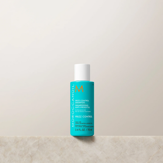 Moroccanoil bottle on a light beige background