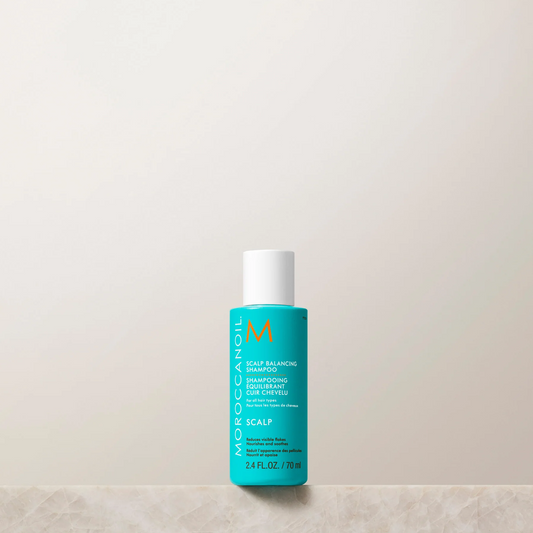 Moroccanoil bottle on a light beige background