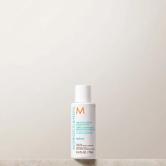 Moroccanoil bottle on a light beige background