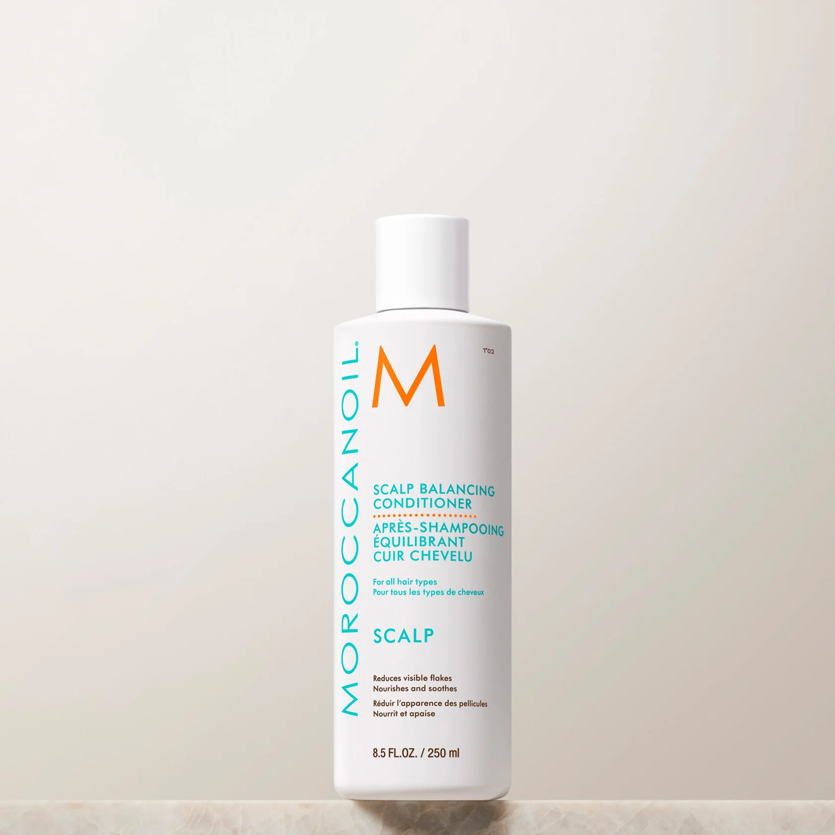 Moroccanoil scalp conditioner bottle on a light background