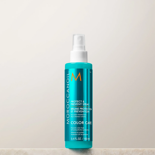 Moroccanoil bottle on a light beige background