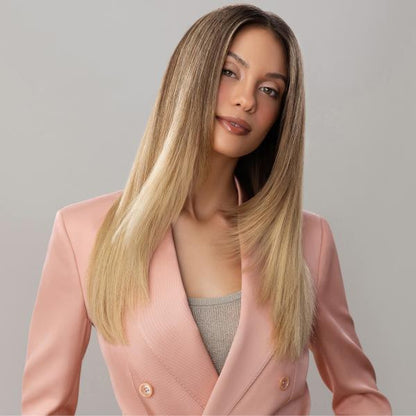 Woman wearing a pink blazer against a gray background