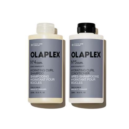 Two Olaplex bottles, one for shampoo and one for conditioner, on a white background.