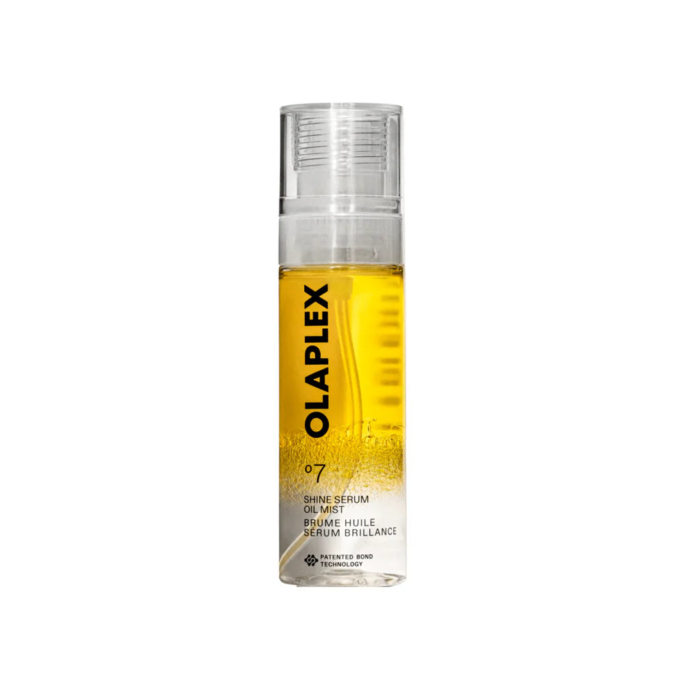 Olaplex No.7 Shine Serum Oil Mist in a clear cylindrical bottle with a transparent cap, showing the golden-yellow oil inside, on a plain white background.