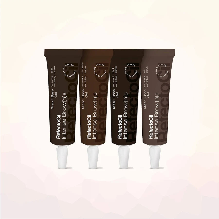 Four tubes of Reflecta-Cil Intense Browns hair dye arranged in a row against a light beige background with subtle geometric patterns.